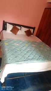 a bed in a room with at Pink villa inn in Guwahati
