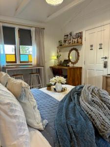 a bedroom with a bed and a table with a mirror at Edington on Mary - The Dairy in Gympie