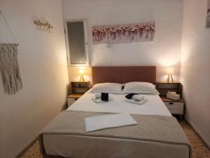 a bedroom with a bed with two towels on it at SeaShell apartment Sea View, Castle View 200metres from the Beach in Sitia +43 photos