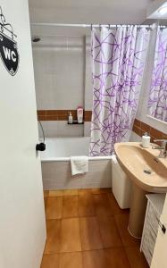 a bathroom with a shower curtain and a sink at Apartamento Tossa in Tossa de Mar +13 photos
