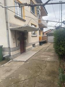 an umbrella on the front of a building at Уютът на Ясен in Yasen