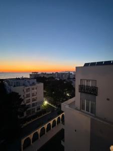 a view of a city at sunset from a building at Sako Apartaments 2 in Golem