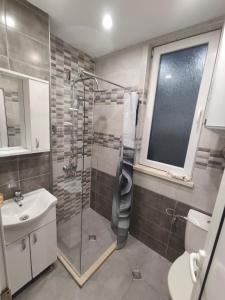 a bathroom with a shower and a toilet and a sink at Уютът на Ясен in Yasen +60 photos