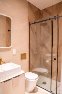 a bathroom with a shower and a toilet and a sink at Epos by the Sea in Larnaca +43 photos