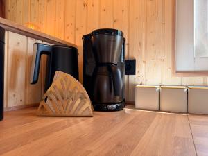 a coffee maker sitting on top of a kitchen floor at CRASH'NSTAY - Moppie Avenue in Hooge Vaart