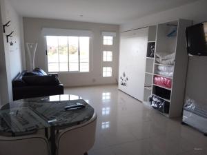 a living room with a couch and a glass table at Luz de faro in Mar del Plata +19 photos
