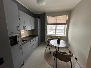 a kitchen with a table and chairs and a window at Villa Karijoki in Karijoki +29 photos