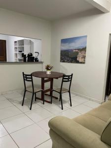 a living room with a table and chairs and a couch at Casa em Seabra in Seabra
