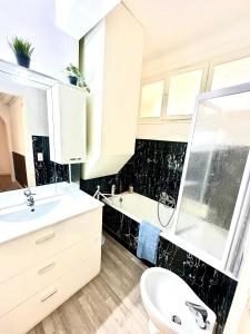 a bathroom with a sink and a toilet and a tub at Monaco Home just 200 mt from Casinò Monte Carlo in Monte Carlo