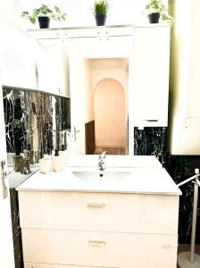 a bathroom with a white sink and a mirror at Monaco Home just 200 mt from Casinò Monte Carlo in Monte Carlo