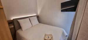 a small bedroom with a bed with a stuffed animal at Gîte isolé avec terrasse in Laignes