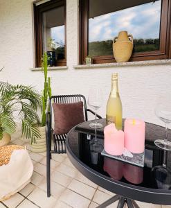a table with a bottle of wine and candles at Auszeit in Bullay +19 photos