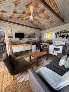 a living room with a couch and a table at Edington on Mary - The Dairy in Gympie