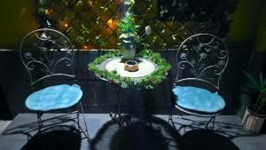 two chairs and a table with a vase on it at VICTORIAN HOUSE in Sibiu