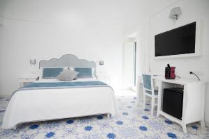 a white bedroom with a bed and a desk at Guesthouse with Suites on the Amalfi Coast - Residence Villa Ruocco near Amalfi - 300sqm Open Terrace near Ravello - Breathtaking View in Scala