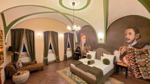 a room with a bed and a portrait of a man at VICTORIAN HOUSE in Sibiu