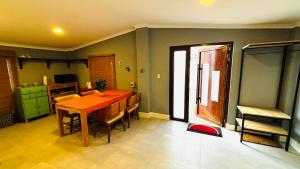 a kitchen and dining room with a table and chairs at Ensuite Condo Aruba in Palm-Eagle Beach