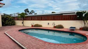 a swimming pool in the middle of a brick yard at Ensuite Condo Aruba in Palm-Eagle Beach +6 photos
