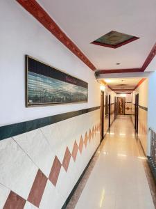 a hallway in a building with a sign on the wall at Shree Sanwariya Hotel in Chittaurgarh +2 photos