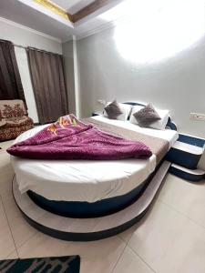 a bedroom with a large bed in a room at Shree Sanwariya Hotel in Chittaurgarh