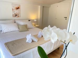 a bedroom with a bed with towels and flowers on it at Villa Infinity View in Široki Brijeg +43 photos