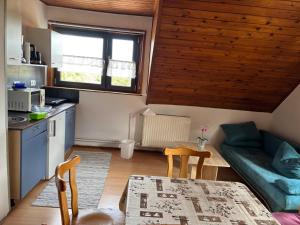 a kitchen and a living room with a table and a couch at Appartment Sylvia von Skwarczinsky in Tabarz