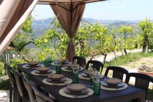 a table with glasses and plates on it with a view at Quinta das Flores da Mãe in Folhada