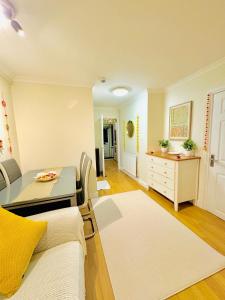 a living room with a couch and a table at Unnati stay in Buckinghamshire