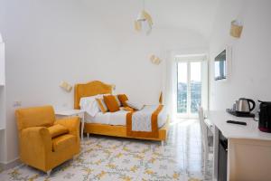 a bedroom with a bed and a chair at Guesthouse with Suites on the Amalfi Coast - Residence Villa Ruocco near Amalfi - 300sqm Open Terrace near Ravello - Breathtaking View in Scala +85 photos