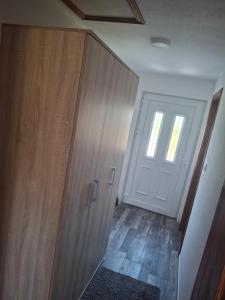 an empty room with a door and a hallway at Vikendica Popadić in Vukovina