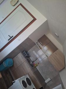 an overhead view of a kitchen with wooden cabinets at Vikendica Popadić in Vukovina +1 photo