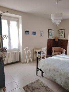 a bedroom with a bed and a table and a window at Via Funicolare in Brunate
