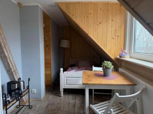a small bedroom with a bed and a table at BP Hostel Gdynia in Gdynia