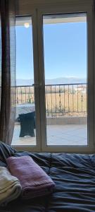 a bedroom with a bed and a window with a view at ΚΑΡΔΙΤΣΑ οικογενειακο in Karditsa