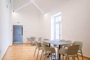 a room with tables and chairs in a room at Epos by the Sea in Larnaca