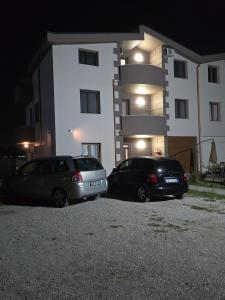 two cars parked in front of a building at night at Le stanze Della Luna in Valjiosi