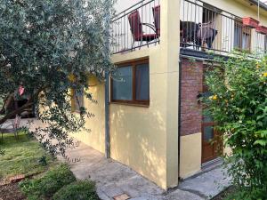 a yellow building with chairs on a balcony at Apartment Stolac in Stolac +2 photos