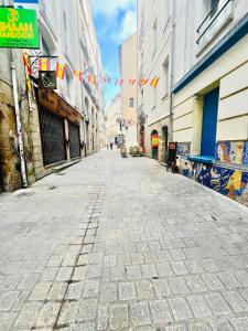 an empty street in a city with flags and buildings at Apparthotel Beauregard 12 cœur de Nantes WIFI in Nantes