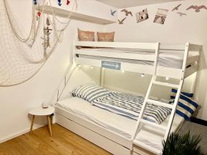 a bunk bed in a room with a ladder at Studio Weidenkorb in Vaihingen an der Enz +21 photos