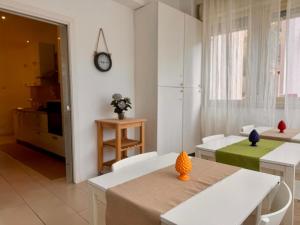 a living room with a table and chairs and a clock at Respiro Mediterraneo in Mondello