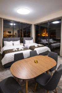 a hotel room with two beds and a table at Natali Apart-hotel in Tbilisi City