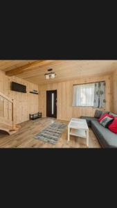 a living room with a couch and a table at Spiska Chatka in Kacwin