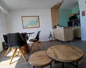 a living room with two chairs and a table at Studio très belle vue mer in Pléneuf-Val-André
