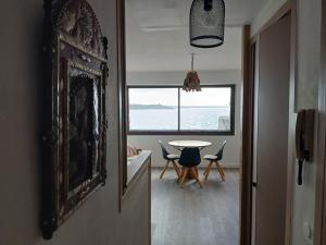 a dining room with a table and a view of the ocean at Studio très belle vue mer in Pléneuf-Val-André +19 photos