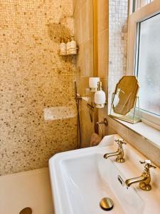 a bathroom with a sink and a shower at Moody House in Congleton