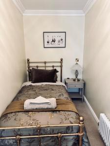a bedroom with a bed and a side table at Moody House in Congleton