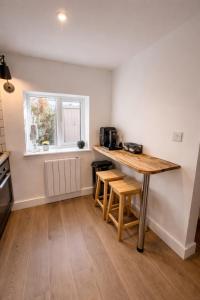 a kitchen with a wooden table in a room at 1 Bridge Rd in Cranleigh