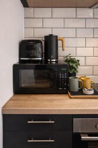 a microwave sitting on top of a counter in a kitchen at 1 Bridge Rd in Cranleigh