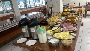 a long buffet of food on a table at Hotel Iung in Alfredo Wagner