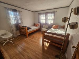 a small room with a bed and a couch at Dracut Executive Rooms with Kitchen & Bath, Parking, Spacious & Comfortable in Dracut